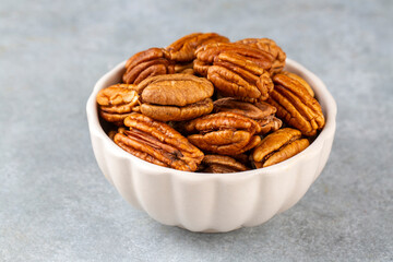 Fototapeta premium Tasty pecan nuts in bowl