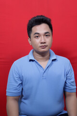 Fototapeta premium Asian man looks sharply at the camera