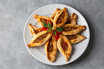 Dishes from traditional Turkish cuisine; Mini pita with minced meat - Turkish name; Kiymali mini pide