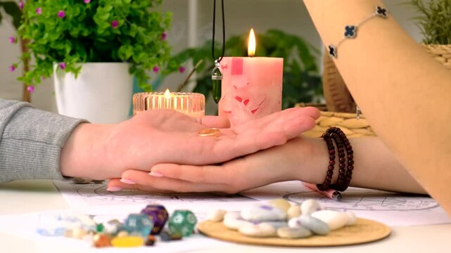 fortune telling with a pendulum on the hand. Selective focus.