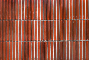 Vertical red subway tiles with white grouts. Seamless tiles background texture.