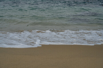 Peaceful Seaside Scene with Soft Waves and Golden Sand