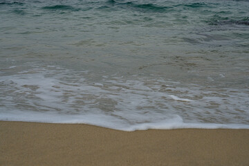 Peaceful Seaside Scene with Soft Waves and Golden Sand