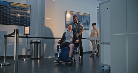 Security Checkpoint in Airport Terminal: Man with Prosthetic Leg Getting Up from Wheelchair,...