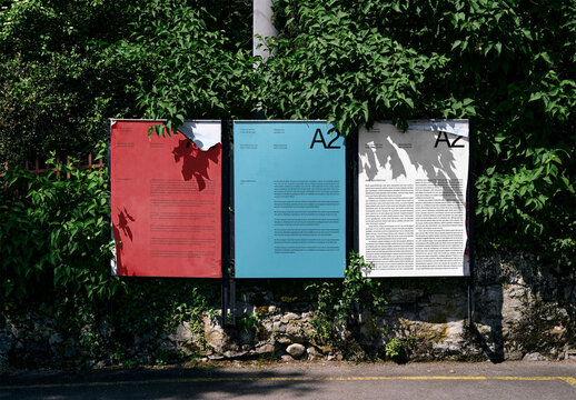 Mockup Of Three Vertical A2 Customizable Posters Outdoors