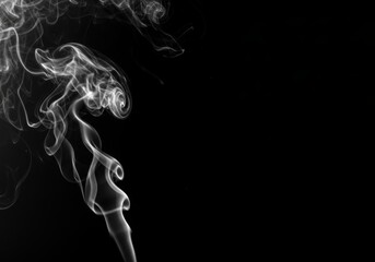 Fototapeta premium Wispy white smoke rising against a stark black background creating an ethereal atmosphere effect