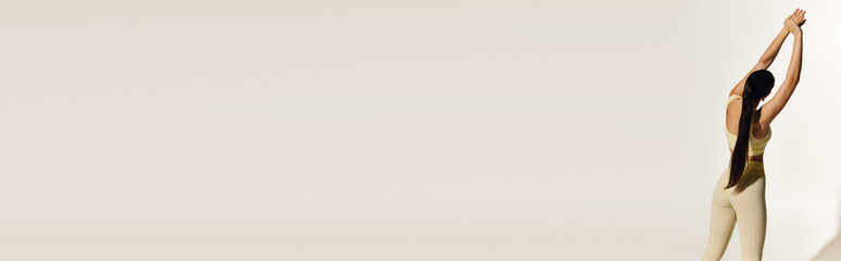 Young sporty woman stretching gracefully in a modern indoor setting