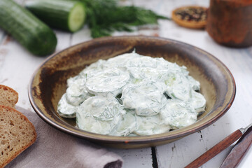 A traditional Polish salad Mizeria in rustic style	