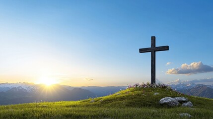 Cross atop a hill during a serene sunset.