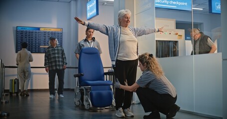 Security Checkpoint: Female TSA Officer Checking Elderly Woman Getting Up from Wheelchair in...