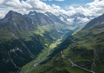 Obraz premium Mountain Valley Vista: Majestic mountain range forming a valley, with lush greenery embracing the winding road. Serene landscape, capturing the majesty of nature.