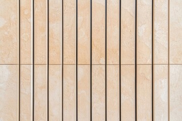 A modern, abstract facade incorporating gold and black elements, photographed from an oblique angle and displaying a sun reflection, serves as an architectural background