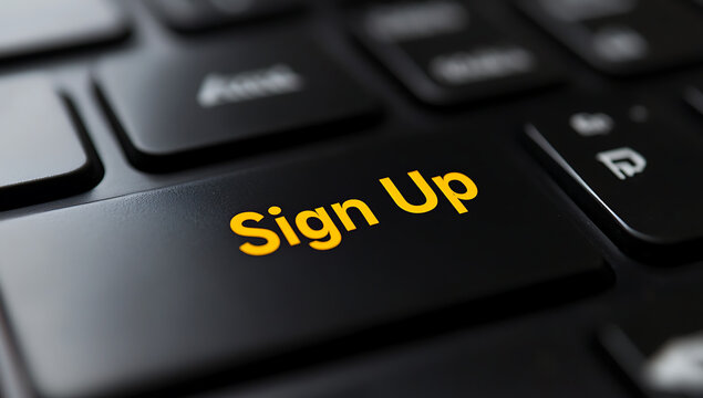 Close up of a black keyboard with a sign up button in yellow text