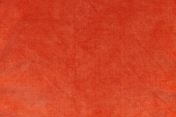 rust colored textured fabric.