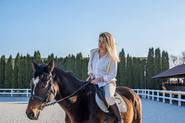 Fototapeta premium Woman with a horse, countryside place, lady talking to her horse. Portrait of riding horse with woman at rancho
