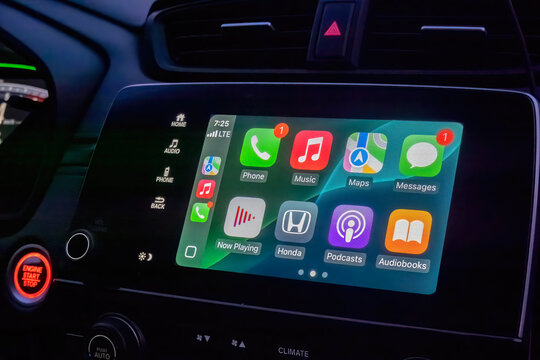 Calgary, Alberta, Canada. Mar 23, 2025. A close-up of a Honda CR-V's infotainment system displaying Apple CarPlay, showcasing various app icons on a vibrant, user-friendly interface.