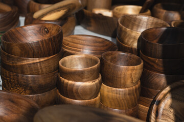 Handmade wooden bowls on a market stall. Selective focus.