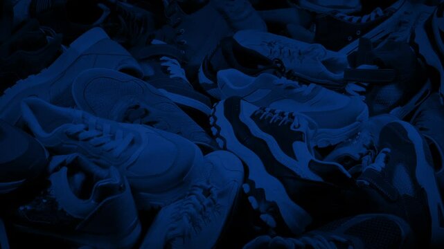Sports Shoes Pile In Dark Room