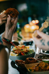A group of people are eating at a table with a variety of food