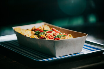 A tray of food with a white box and blue stripes