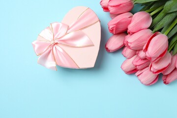 Happy Mother's day. Beautiful bouquet of fresh tulips with gift box on a colored background