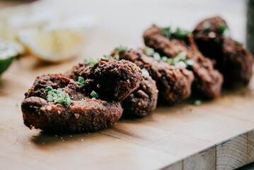 A plate of fried chicken with green herbs on top