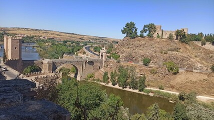Fototapeta premium ancient bridge and ruins on a hill