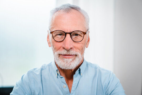 Happy middle aged senior professional business man, smiling mature executive ceo manager, 60 years old male entrepreneur, confident business owner wearing glasses in office. Headshot portrait.