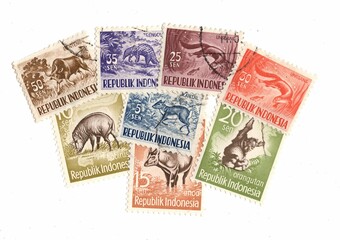 Vintage postage stamps from Indonesia on a white background.