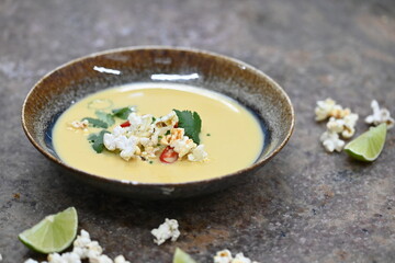 Vibrant Yellow Corn Soup with Popcorn, Chili, and Cilantro – Restaurant Serving
