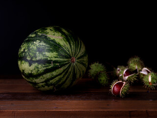 Studio still life of a watermelon on dark background. Vivid colors and controlled lighting highlight texture, freshness, and artistic contrast in a professional studio setting.