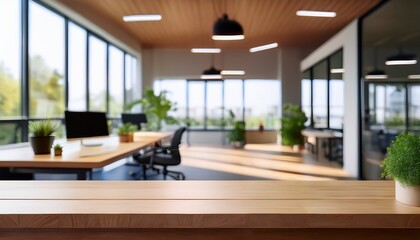 modern office interior with empty wooden table in foreground and blurred workspace background showcasing natural light and decor