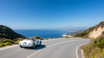 Vintage convertible car driving along winding coastal road in greece
