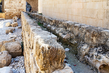 Acre, Israel – January 23, 2025, Aqueduct in Akko Castle near the stone fortress wall.