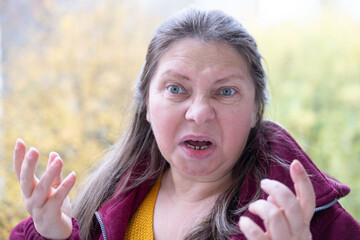 furious mature woman glares, showing anger, rage and frustration, Threatening expression on Female...