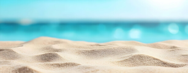 Obraz premium A serene beach scene featuring soft, golden sand and tranquil turquoise waters, perfect for relaxation and escape.