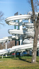 Outdoor spiral water slide in amusement park, summer adventure leisure, family vacation fun activity