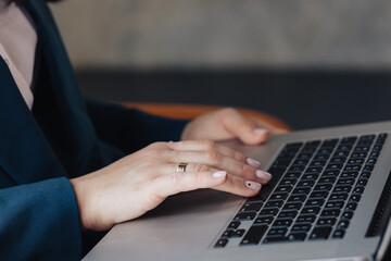 Close-up of Hands Typing on a Laptop Keyboard in Office