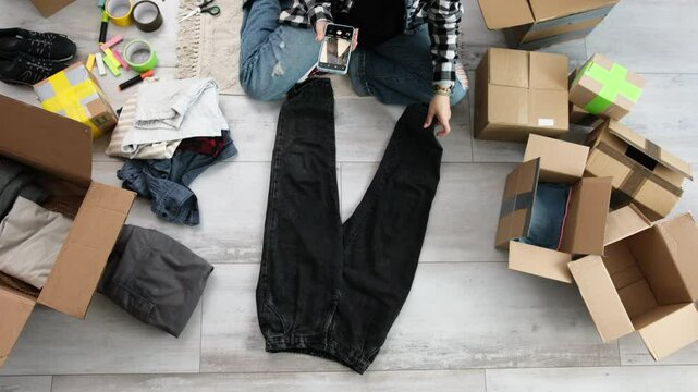 Girl Takes Photos Of Pre-Owned Clothes To Sell Online, Focusing On Selling Second-Hand Items