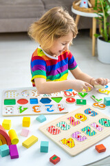 Fototapeta premium Child learns numbers and letters. Selective focus.