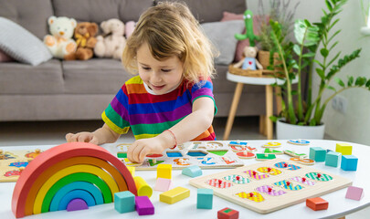 Child learns numbers and letters. Selective focus.