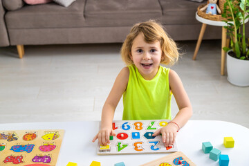 Fototapeta premium Child learns numbers and letters. Selective focus.