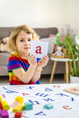 Child learns numbers and letters. Selective focus.