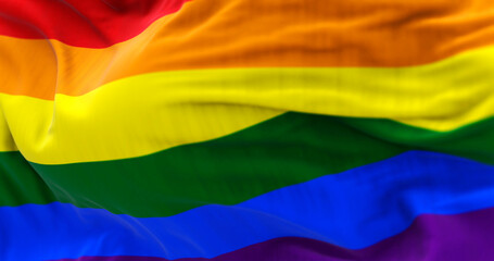 Colorful rainbow pride flag waving dynamically in the sky