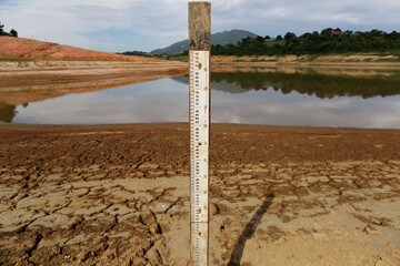 Low level of water is measured by a gauge in a reservoir dam during a severe drought in Sao Paulo,...