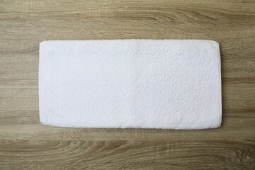 Bath towel on wooden background