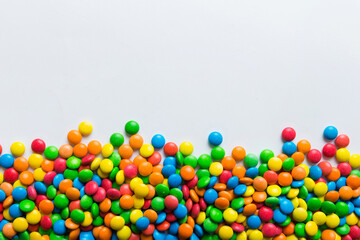 Mixed collection of colorful candy, on colored background. Flat lay, top view. frame of colorful chocolate coated candy