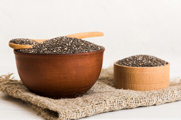 Chia seeds in bowl and spoon on colored background. Healthy Salvia hispanica in small bowl. Healthy superfood