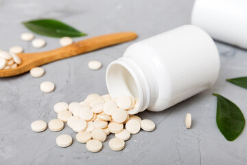 different drugs and health supplement pills poured from a medicine bottle health care and medical...