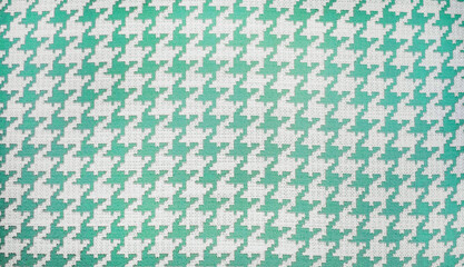 close-up shot of a beige and green houndstooth pattern on a woven fabric, showcasing the classic textile design suitable for fashion and interior applications, repeating  pattern background.